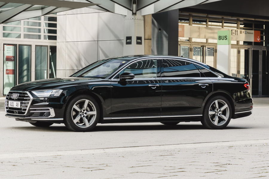 Limousines A black Audi A8 represents the "Progressive Luxury" of the business class, featuring a sleek, understated aesthetic with its massive Singleframe grille, signature HD Matrix LED lighting, and a technical precision that makes it the preferred choice for high-end corporate travel.