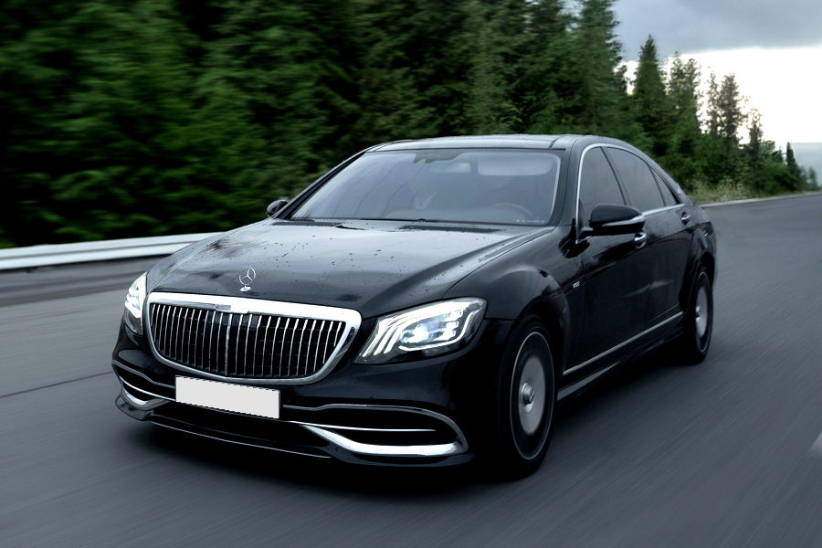 Limousines A black Mercedes-Maybach exudes timeless authority, featuring a glossy obsidian finish that perfectly highlights the signature chrome-plated double-M grille and the elongated, majestic silhouette.